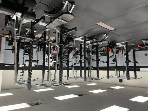 Weight racks and benches in the fitness center.